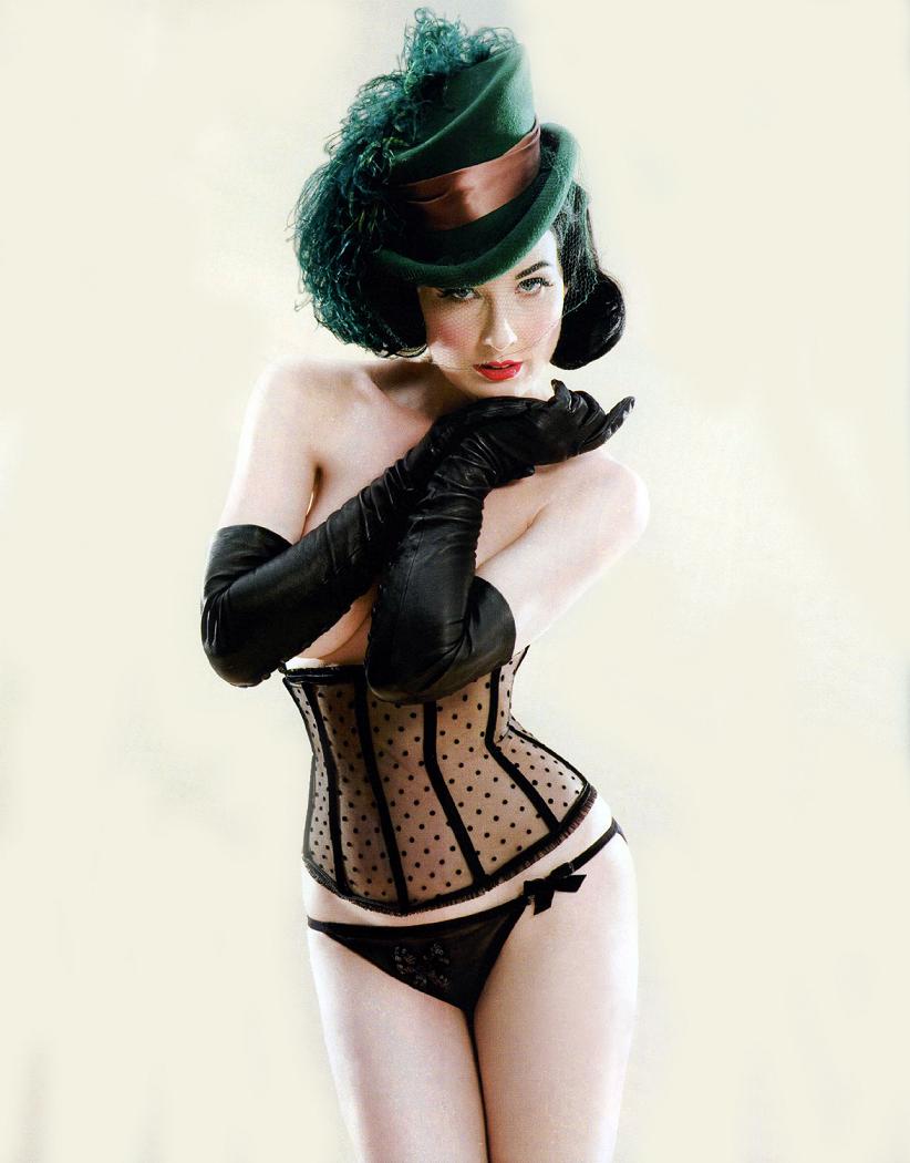Dita von Teese in a lace basque and leather opera gloves.