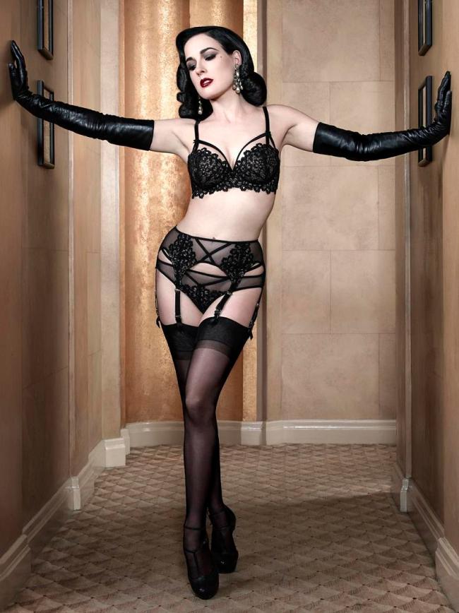 Dita von Teese just stretching out in her leather opera gloves and stockings.