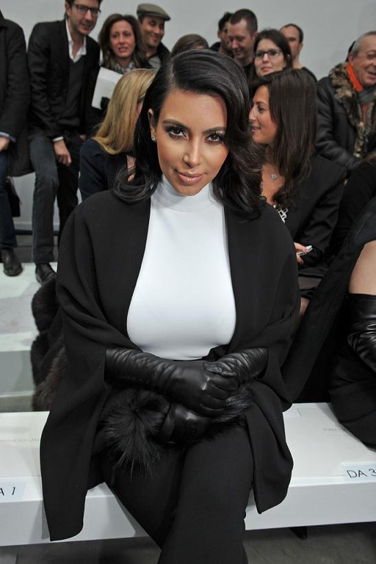 Kim Kardashian wearing black leather opera gloves at a Paris fashion show
